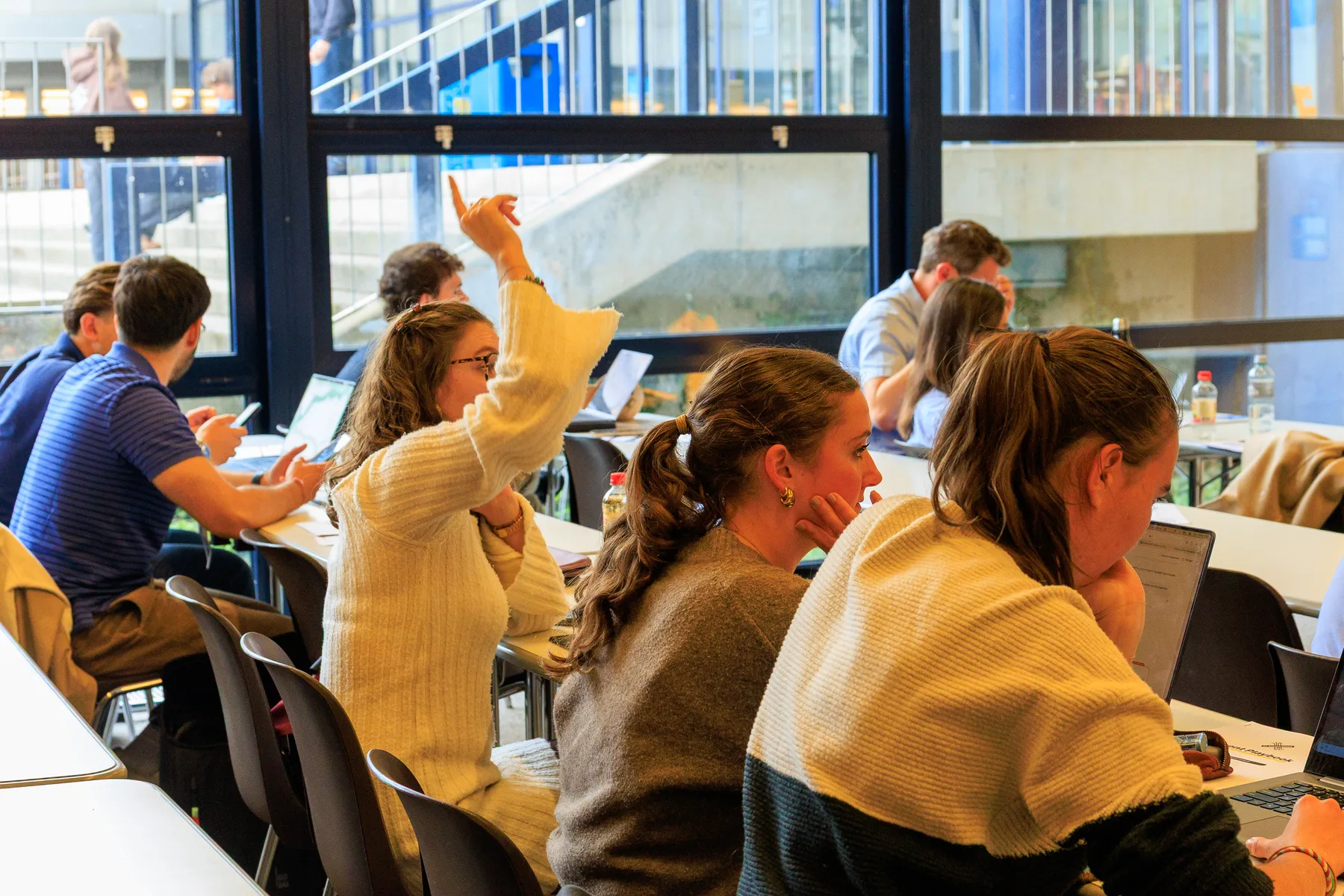 A participant asks a question during an AI Workshop session at UNIL in Lausanne
