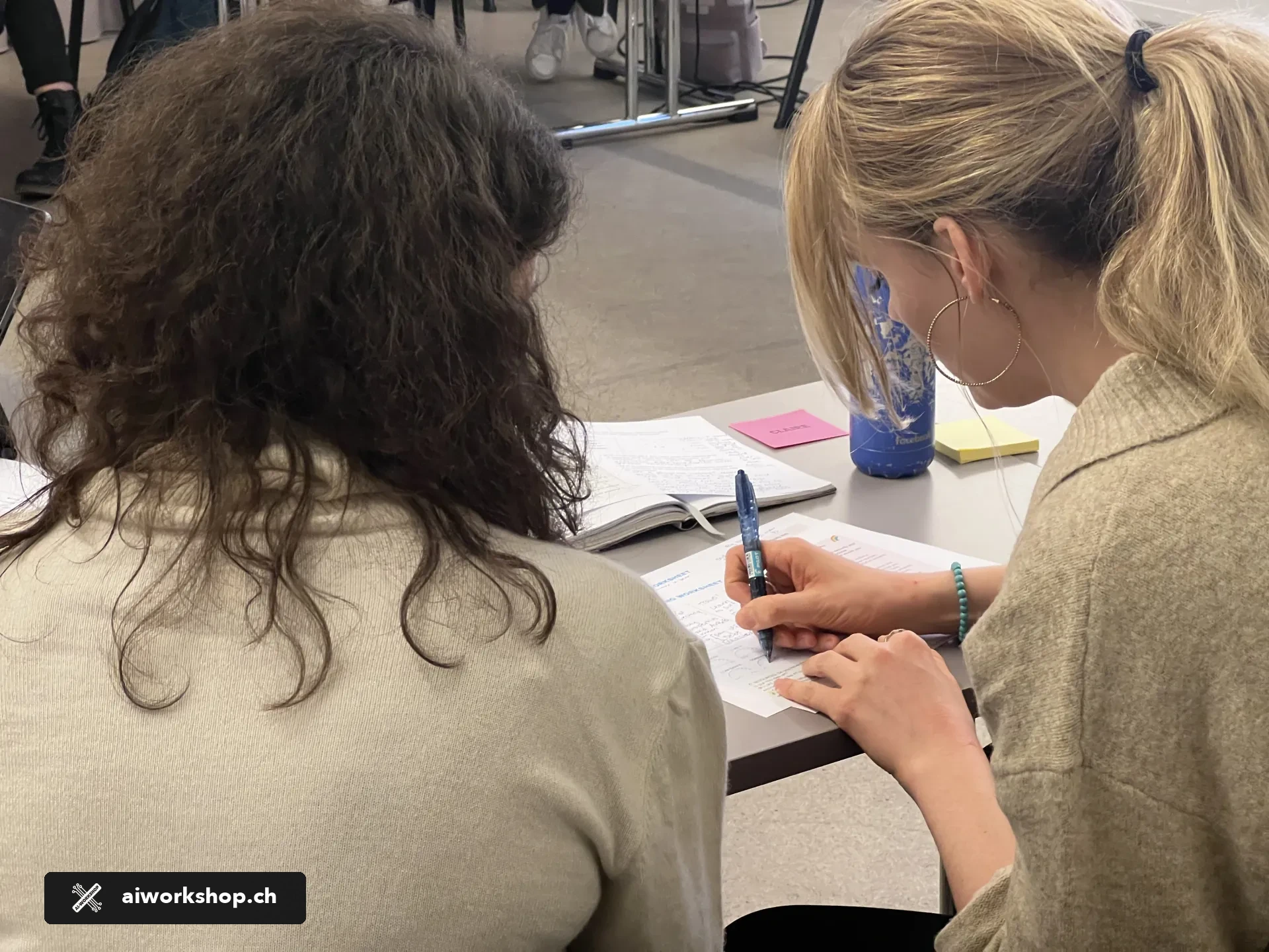 Participants working together during an AI Workshop session in Lausanne